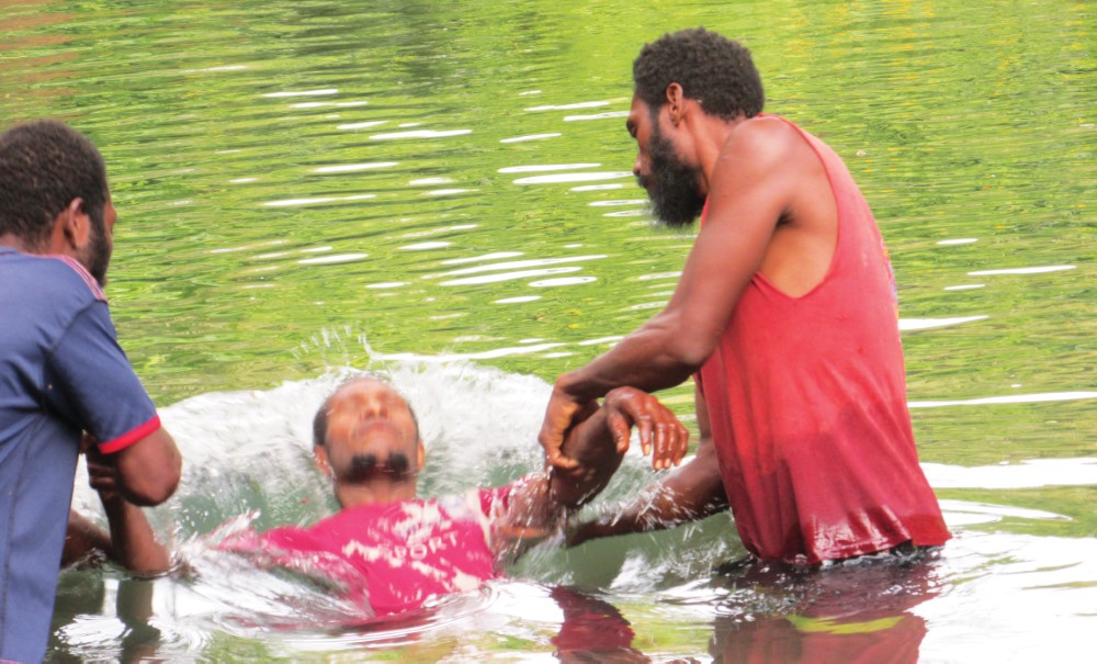 Lusi man being baptized by Lusi man