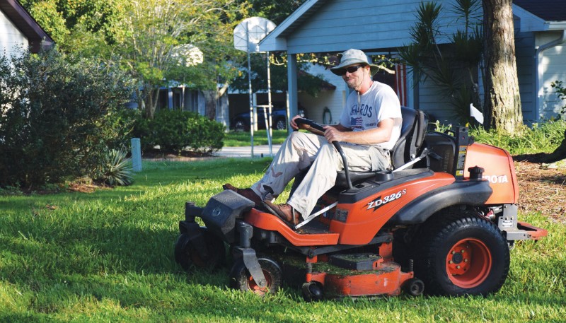 Homes staff member on lawn mower