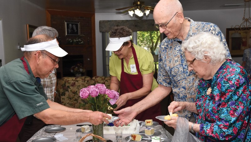 Homes staff serving cake to residents