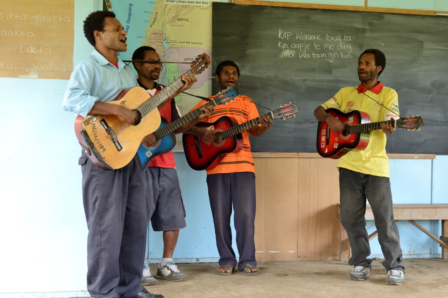 Dinangat people playing guitars and singing